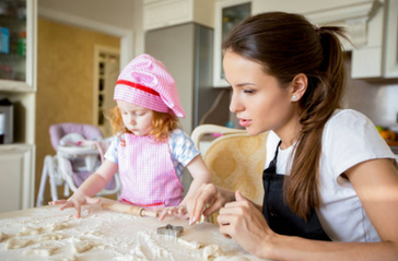 nanny baking with a little girl in the kitchen