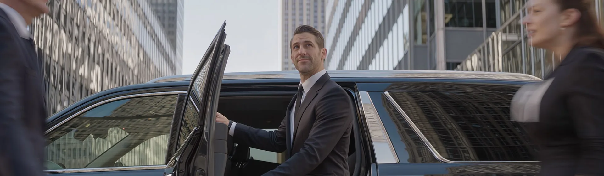 Chauffeur holding a car door open on a Manhattan street